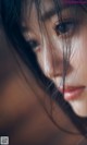 A close up of a woman's face with long black hair.