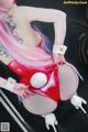 A woman with pink hair wearing a red and white outfit.