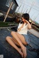 A woman sitting on top of a boat next to a body of water.